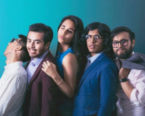 Ana Sofía López junto a su banda en un fondo turquesa