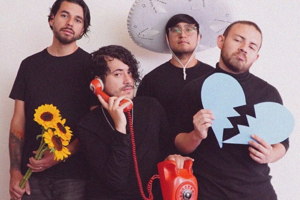 Cementerio de Elefantes posando con girasoles, un teléfono rojo y un corazón de cartulina