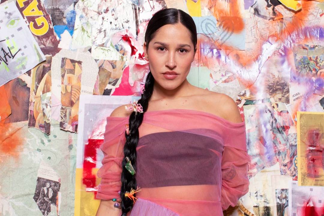 Elsa y Elmar posando frente a un collage de imágenes