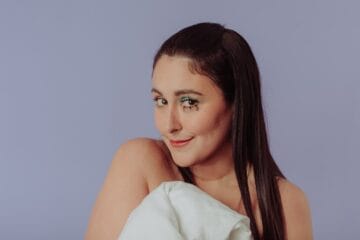 Luciana Arispe posando con un fondo lila