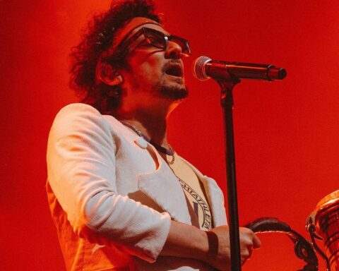 León Larregui sobre el escenario con traje blanco