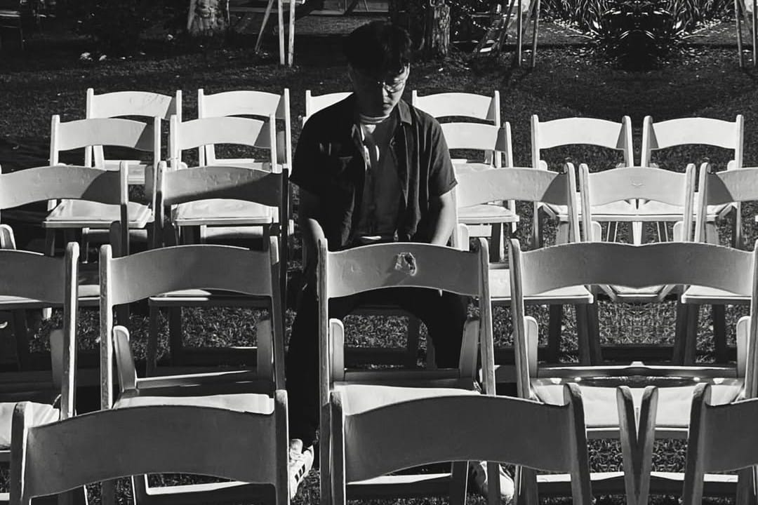 Andrés Zavala parado entre sillas