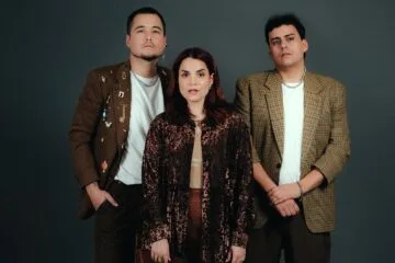 El trío Ves Tal Vez posando frente a un fondo oscuro
