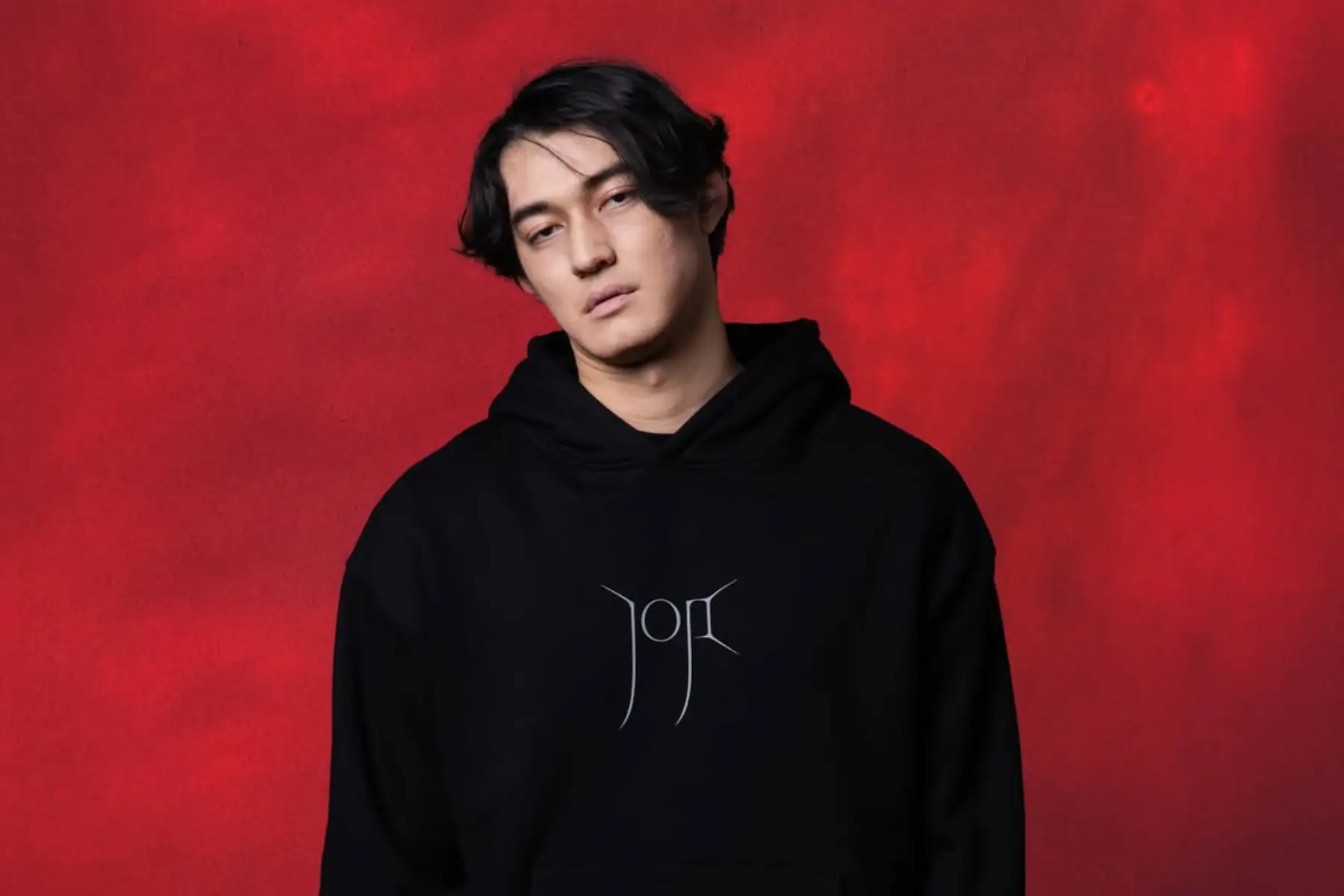 Joji con polera negra y fondo rojo