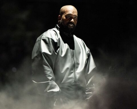 Kanye West con un traje gris en escenario