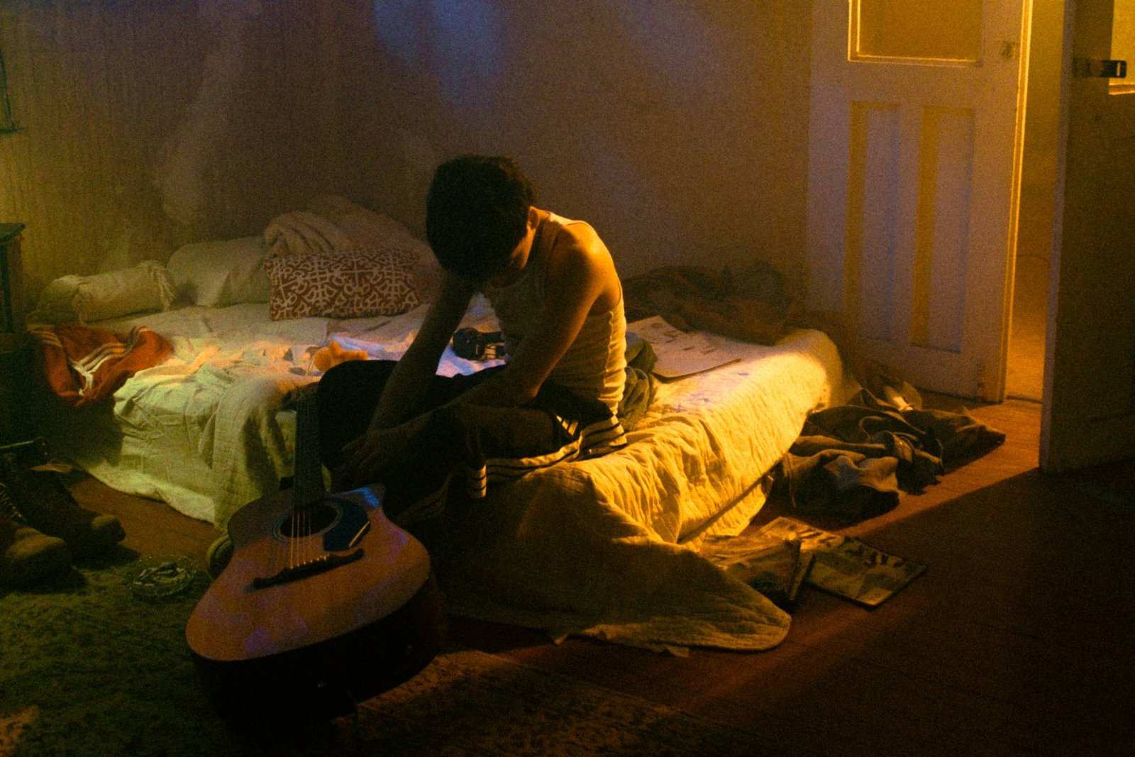 SobresDylan en una cama con su guitarra