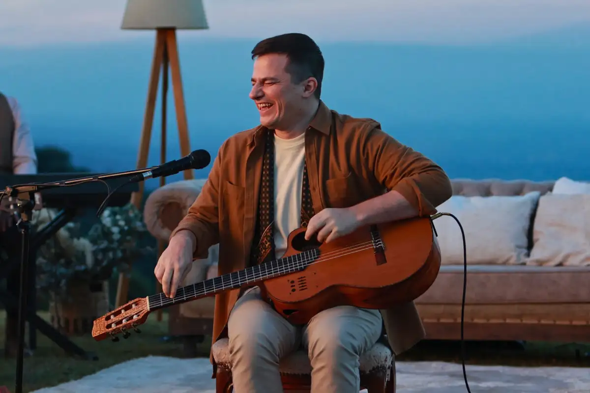 Nahuel Pennisi con su guitarra en una terraza